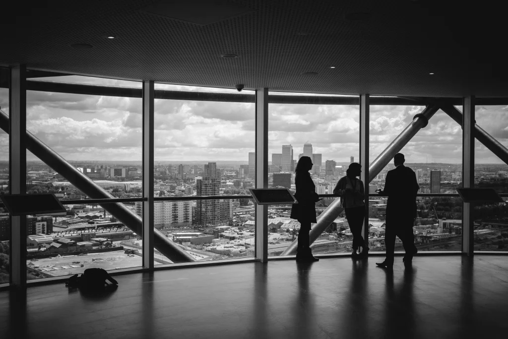 Conversion experts discussing UX strategy in a high-rise office overlooking the city — focused on CRO audits, user research, and digital performance insights